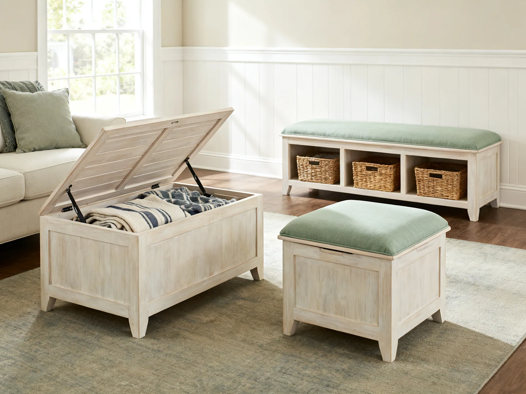 Furniture that stores things A living room with a lift-top coffee table open to show blankets, a lidded ottoman used as a seat, and a bench with baskets underneath
